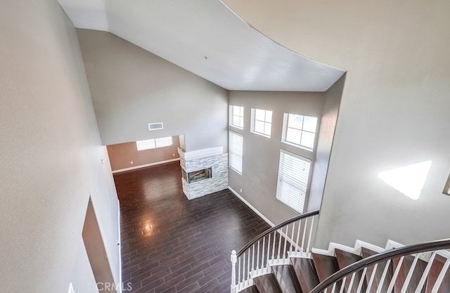 interior space featuring lofted ceiling, dark hardwood / wood-style flooring, and a fireplace