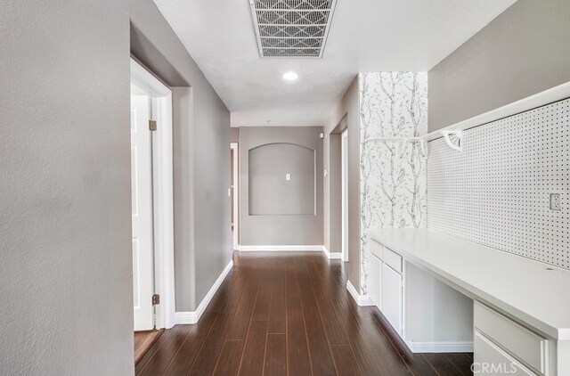 corridor featuring dark wood-type flooring