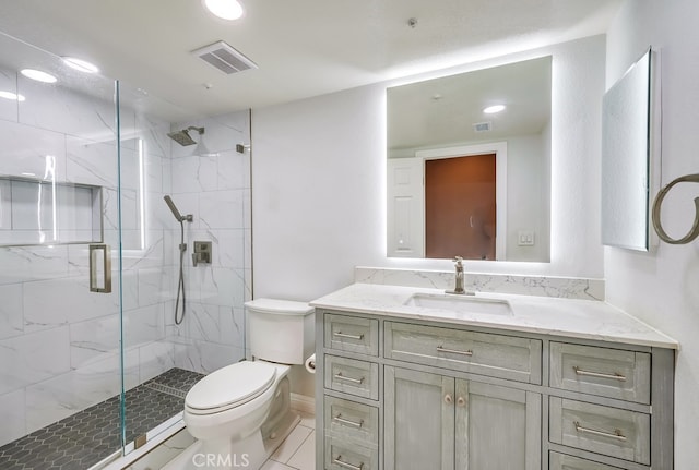 bathroom with toilet, tile patterned flooring, a shower with shower door, and vanity