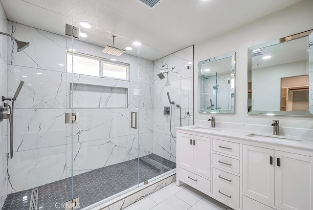 bathroom with an enclosed shower and vanity