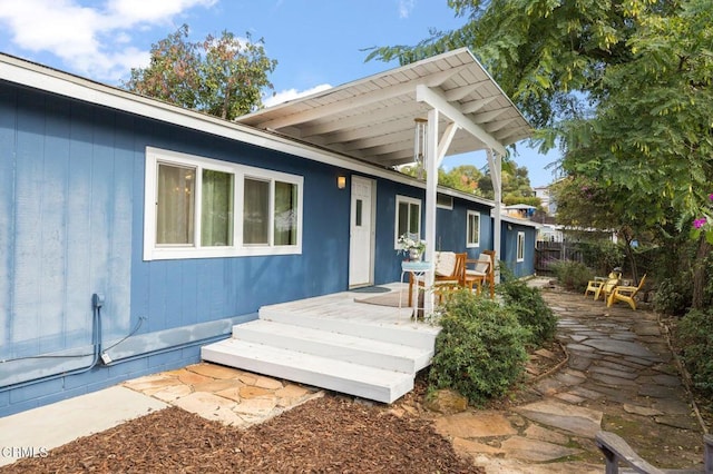 rear view of property featuring a deck