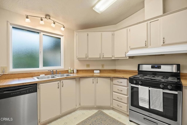 kitchen featuring white cabinetry, sink, lofted ceiling, and stainless steel appliances