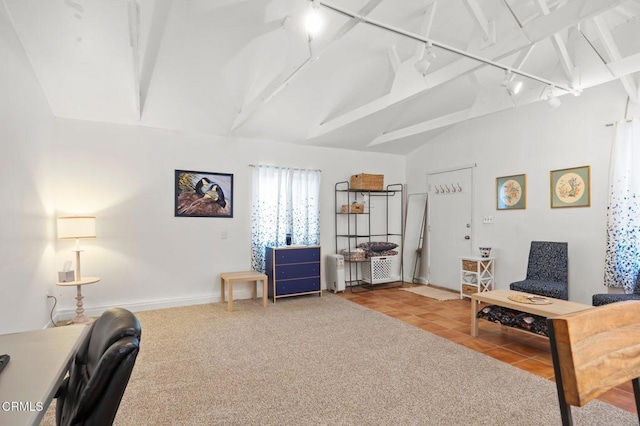 living area with tile patterned flooring, lofted ceiling with beams, and track lighting