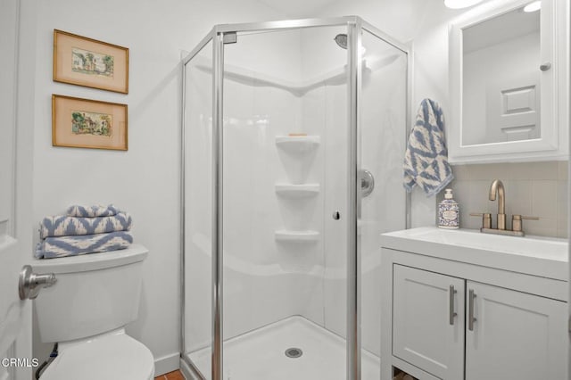 bathroom with decorative backsplash, toilet, an enclosed shower, and vanity