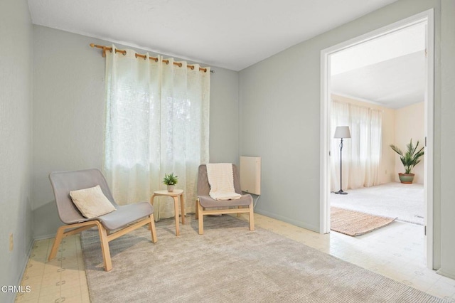 sitting room featuring light carpet