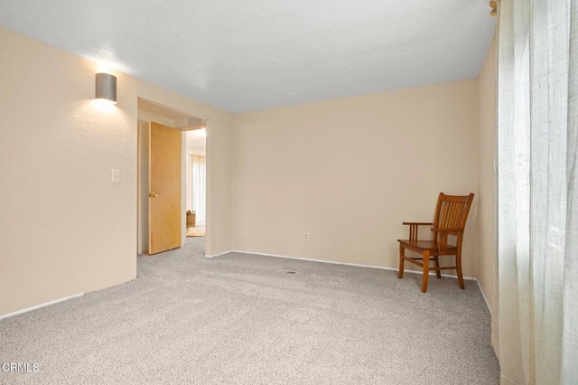 empty room featuring light colored carpet