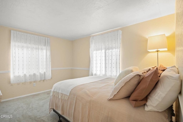 bedroom featuring carpet flooring and multiple windows