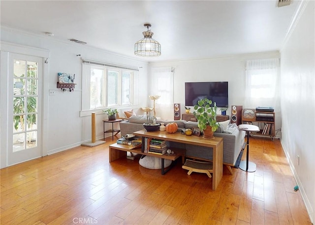 2049 Argyle Ave, Los Angeles, CA 90068 - living room with healthy amount of natural light, crown molding, and light wood finished floors