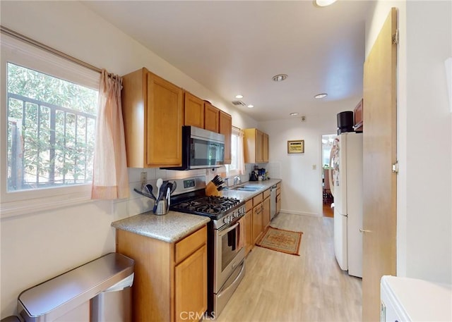 2049 Argyle Ave, Los Angeles, CA 90068 - kitchen with appliances with stainless steel finishes, healthy amount of natural light, light wood finished floors, light countertops, and recessed lighting