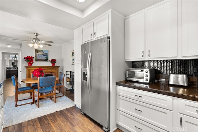 kitchen with ceiling fan, white cabinets, stainless steel fridge, and dark hardwood / wood-style floors