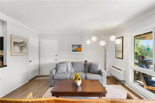 living room featuring a wealth of natural light, hardwood / wood-style flooring, ornamental molding, and a wall mounted air conditioner