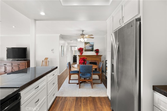 kitchen featuring ceiling fan, white cabinets, dark hardwood / wood-style floors, and stainless steel fridge with ice dispenser