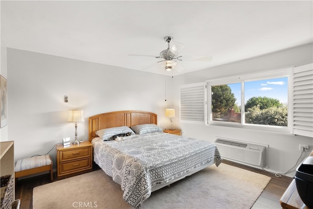 bedroom featuring ceiling fan, dark hardwood / wood-style flooring, and a wall mounted AC