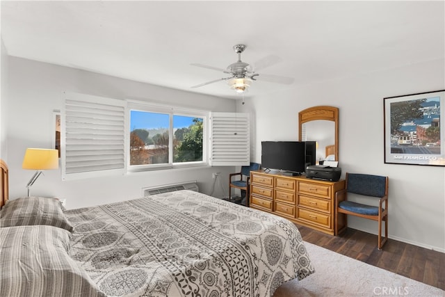 bedroom featuring ceiling fan, dark hardwood / wood-style flooring, and a wall mounted air conditioner