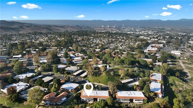 birds eye view of property with a mountain view