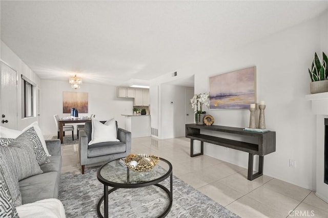 19106 Alamo Ln Unit 169, Yorba Linda, CA 92886 - living area with light tile patterned flooring, a chandelier, and a fireplace
