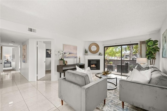 living room featuring light tile patterned flooring and a textured ceiling