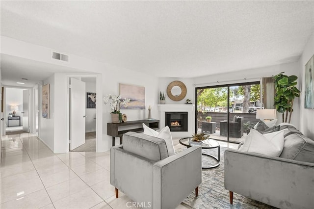 19106 Alamo Ln Unit 169, Yorba Linda, CA 92886 - living area with a textured ceiling, a lit fireplace, and light tile patterned floors