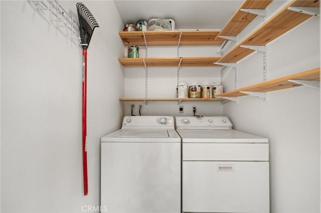 washroom with washing machine and clothes dryer