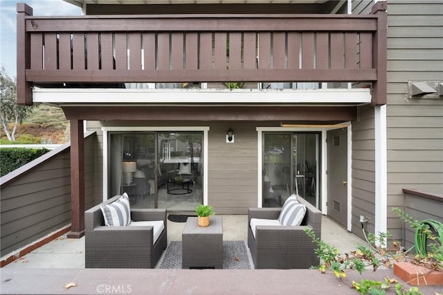 view of patio featuring an outdoor living space and a balcony