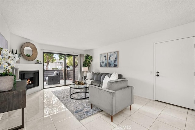 19106 Alamo Ln Unit 169, Yorba Linda, CA 92886 - living area featuring a textured ceiling, a warm lit fireplace, and light tile patterned floors