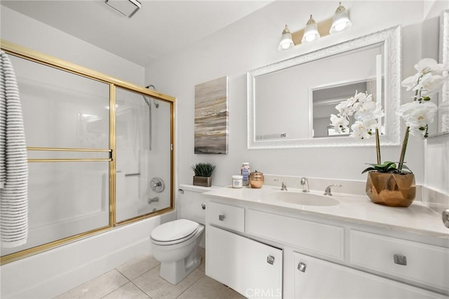 full bathroom with toilet, vanity, tile patterned floors, and bath / shower combo with glass door