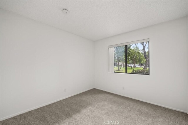 19106 Alamo Ln Unit 169, Yorba Linda, CA 92886 - spare room with carpet floors, a textured ceiling, and a smoke detector
