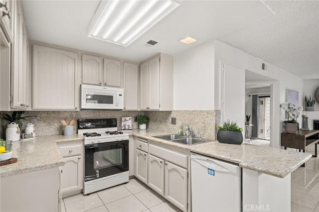 19106 Alamo Ln Unit 169, Yorba Linda, CA 92886 - kitchen featuring white appliances, light tile patterned floors, a peninsula, and decorative backsplash
