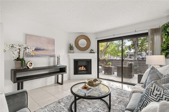 19106 Alamo Ln Unit 169, Yorba Linda, CA 92886 - living room featuring a textured ceiling, tile patterned floors, and a warm lit fireplace