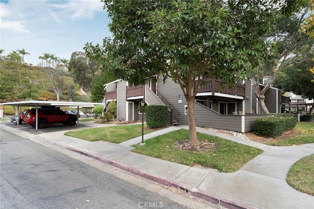 19106 Alamo Ln Unit 169, Yorba Linda, CA 92886 - view of front facade featuring covered parking and a front yard