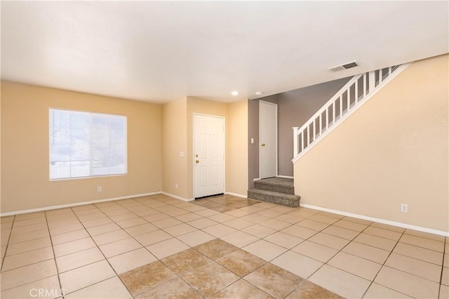 unfurnished room with light tile patterned floors