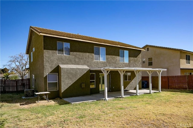 rear view of house with a lawn and a patio area