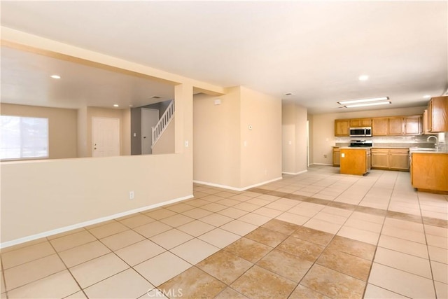 kitchen featuring light tile patterned floors and sink