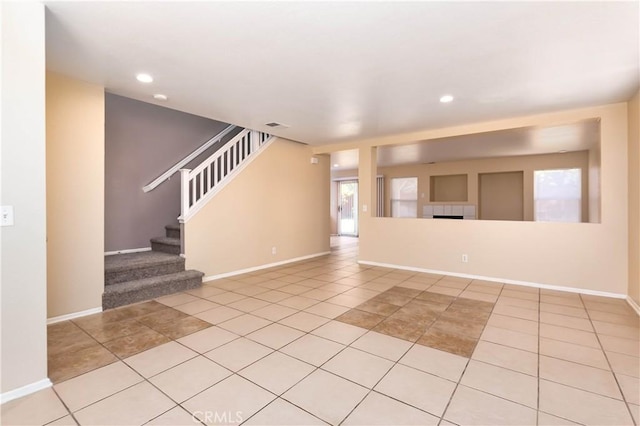 unfurnished living room with light tile patterned flooring