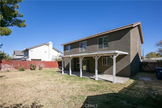 rear view of property with a lawn and a patio area