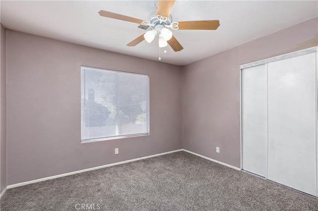 unfurnished bedroom with carpet flooring, ceiling fan, and a closet