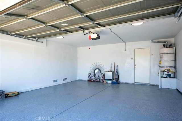 garage with secured water heater and a garage door opener