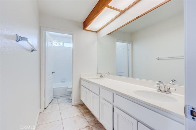 full bathroom with toilet, tile patterned flooring, double vanity, and a sink