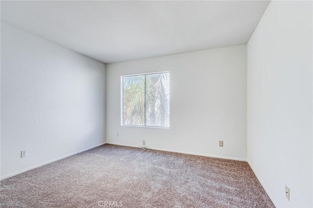 spare room with carpet flooring and baseboards