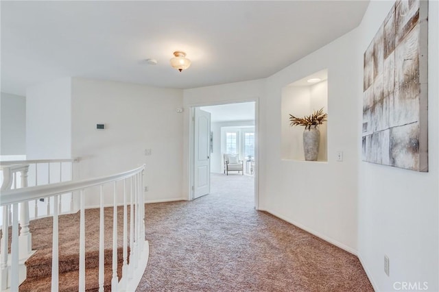 corridor featuring carpet and baseboards