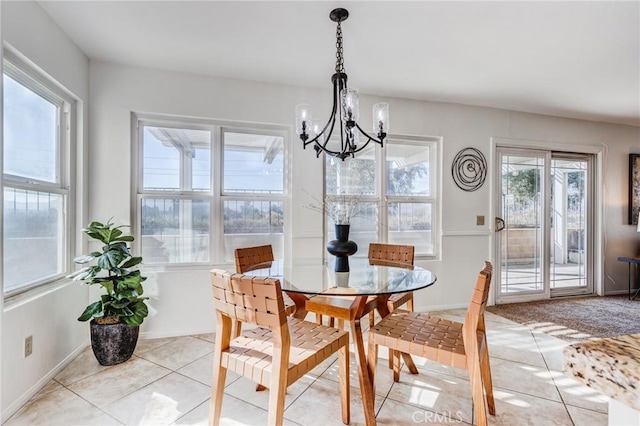 dining room with light tile patterned floors, baseboards, and a notable chandelier