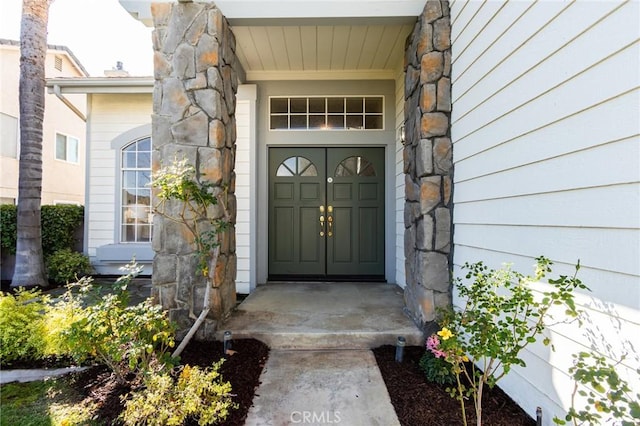 entrance to property featuring stone siding