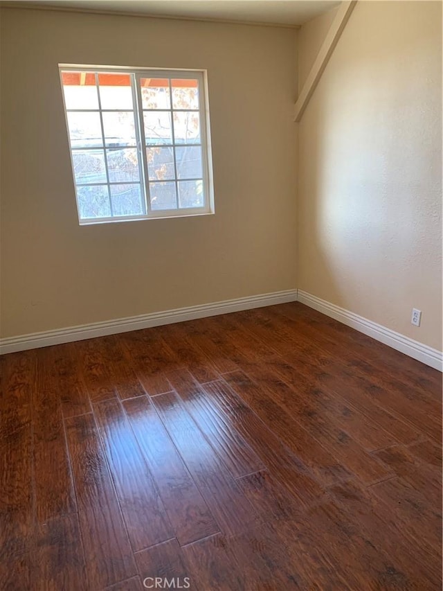 unfurnished room with dark wood-type flooring