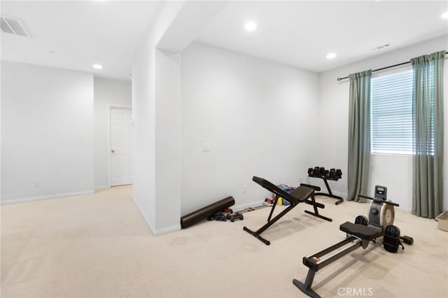 workout room featuring light colored carpet