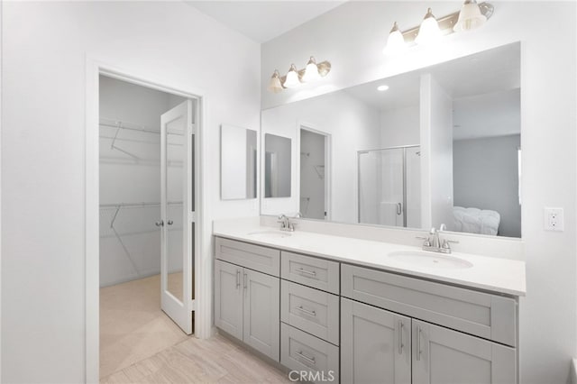 bathroom featuring vanity and a shower with shower door