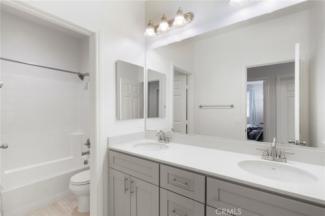 full bathroom with vanity,  shower combination, and toilet