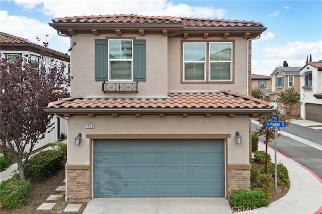 mediterranean / spanish-style house with a garage