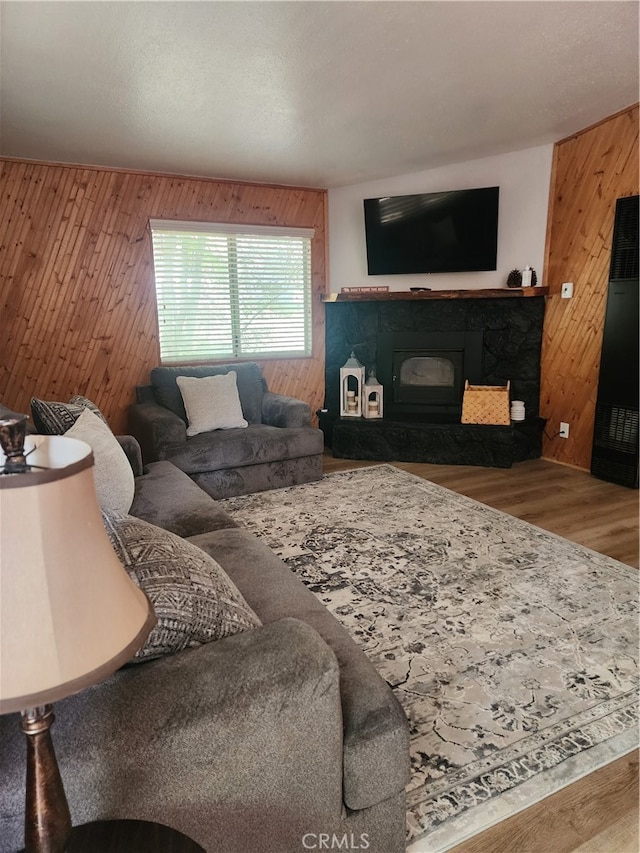 living room with hardwood / wood-style floors and wooden walls