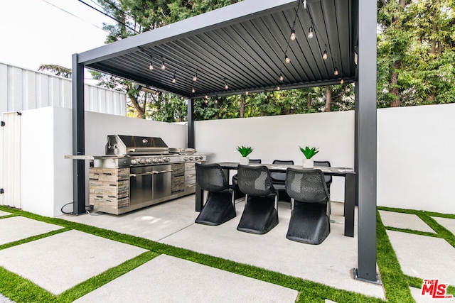 view of patio with grilling area and an outdoor kitchen