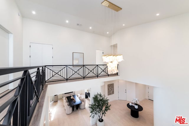 interior space with a towering ceiling and light wood-type flooring